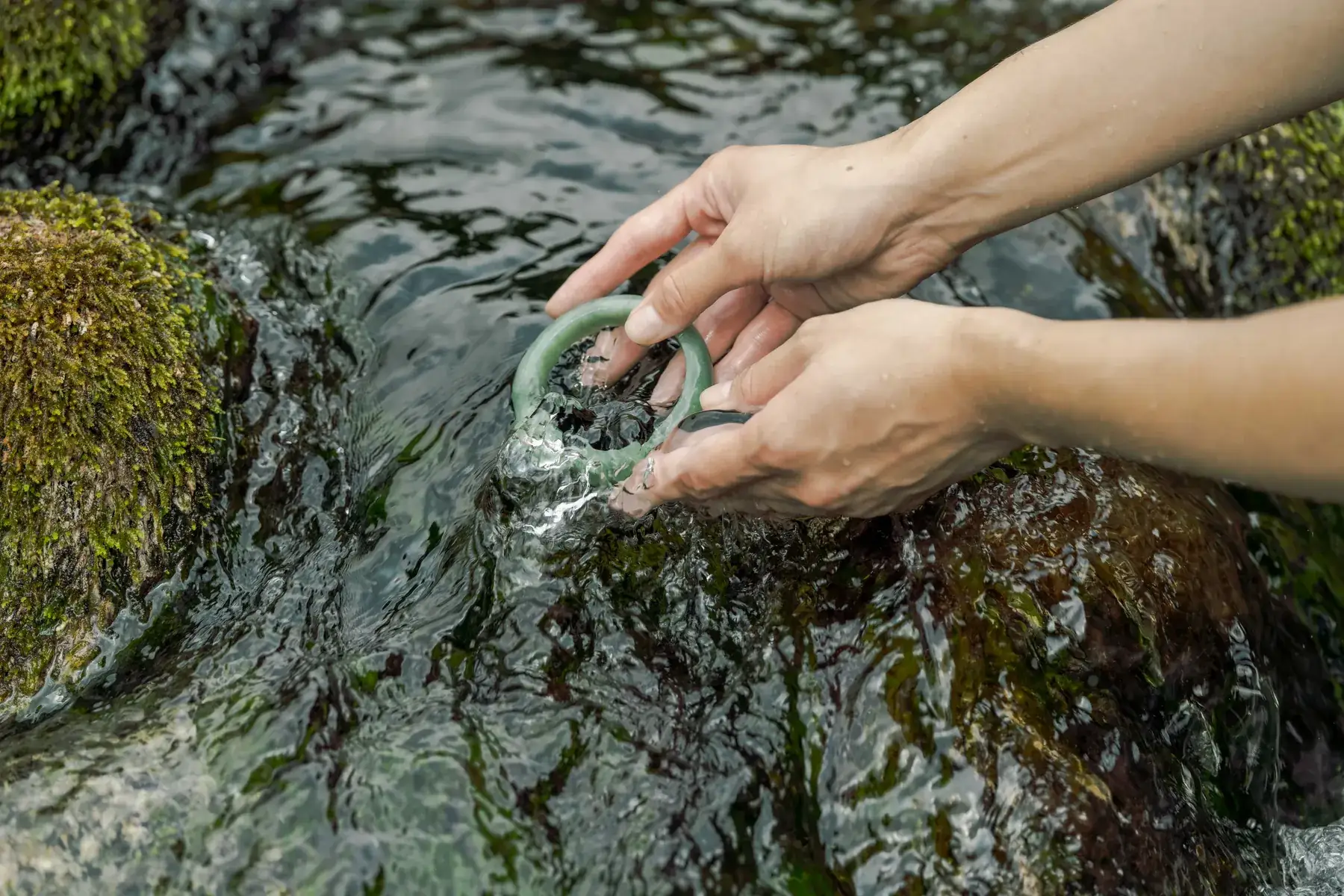 Cleansing a jade bangle in the river at Itoigawa