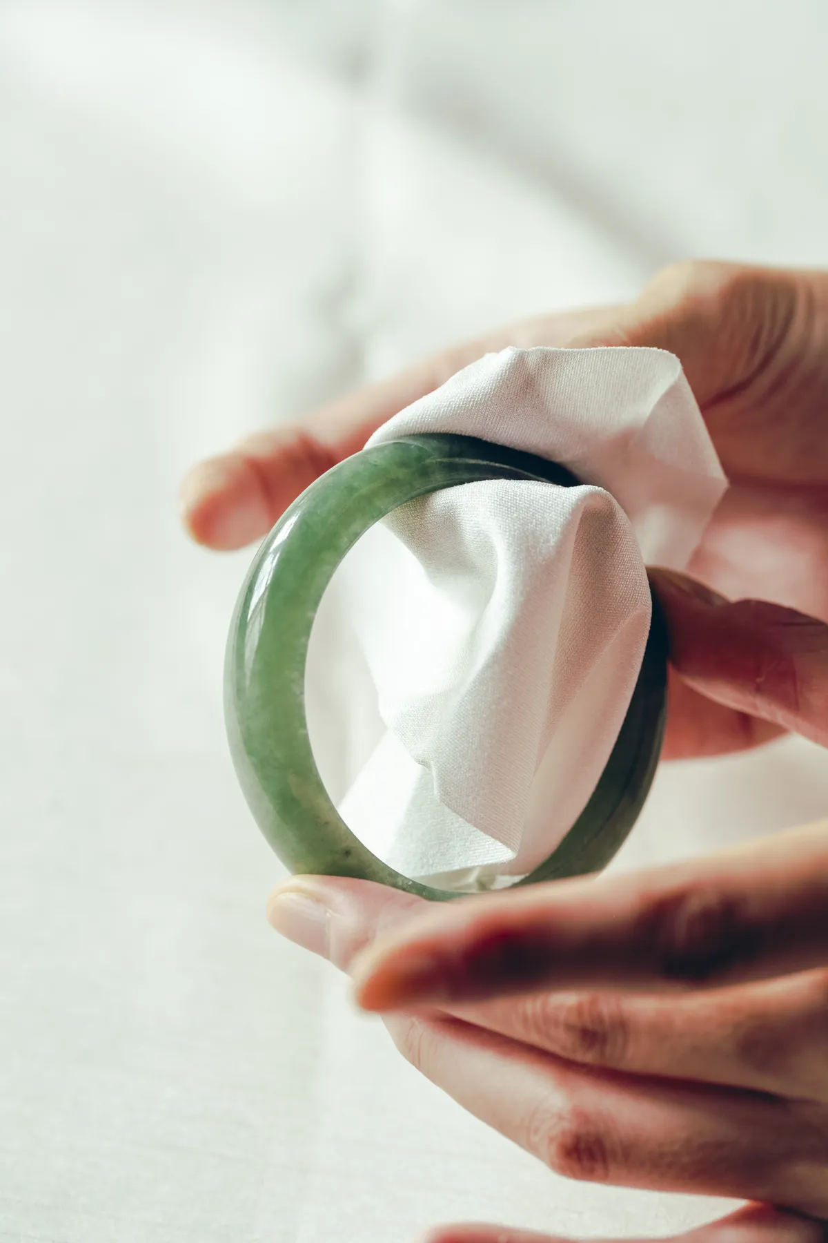Wiping a jade bangle with a soft cloth